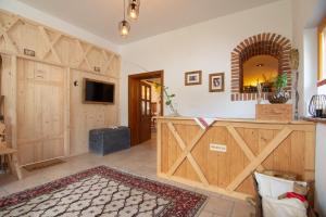 a room with a wooden barn door and a television at Tourist Farm "Pri Biscu" in Bled