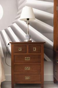 a lamp on top of a dresser in a bedroom at Casa Teresa in Cenes de la Vega