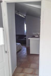 a hallway leading to a room with a kitchen at Studio entre Cévennes et Camargue in Montfrin