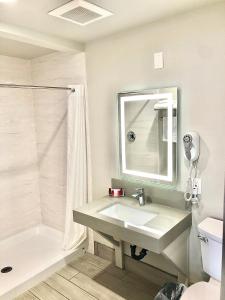 a bathroom with a sink and a shower at Budget Lodge Eugene - Airport in Eugene