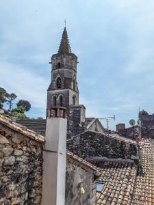 a church steeple on top of a stone building at Studio entre Cévennes et Camargue in Montfrin