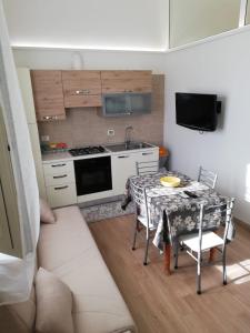 a kitchen with a table and a stove top oven at Villa Lella in Marausa