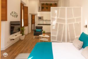 A bed or beds in a room at AiA LOFT BIBRAMBLA