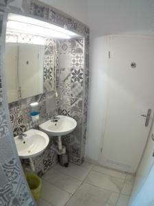 a bathroom with two sinks and a mirror at Anchi Guesthouse in Dubrovnik