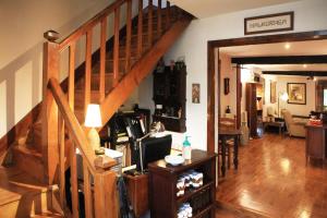 a living room with a wooden staircase and a living room at Casa Rural Malkornea in Maya del Baztán