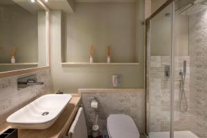 a bathroom with a sink and a toilet and a shower at Villa Aurora in Pula +18 photos