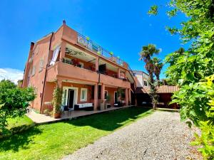 an exterior view of a house with a yard at Apartments Tajana in Novigrad Istria
