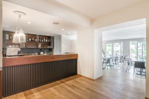 a kitchen and dining room with a bar and tables at Resort Miramonti in Forte dei Marmi
