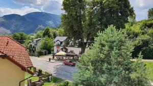 an aerial view of a small village with a red car in front of a building at Pizzeria Alžbetka in Strečno