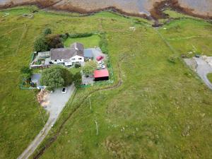 an overhead view of a house on a grass field at Kiloran Self Catering Suite in Skeabost