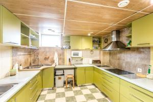 a kitchen with lime green cabinets and a sink at Sea Rooms ENGURE in Engure +91 photos