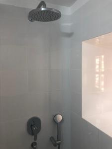 a bathroom with a shower with a light on the wall at Casas Rurales Hermigua in Hermigua +51 photos