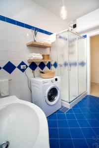 a bathroom with a washing machine and a shower at La Zagara Holiday House - Cetara - Amalfi Coast in Cetara