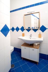 a blue and white bathroom with a sink and a mirror at La Zagara Holiday House - Cetara - Amalfi Coast in Cetara