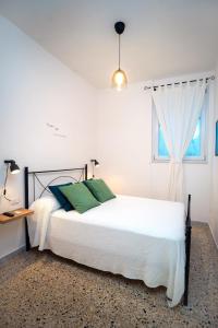 a bedroom with a white bed and a window at La Zagara Holiday House - Cetara - Amalfi Coast in Cetara