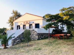 a house with a picnic table in front of it at Kirkos Apartments in Kamariotissa