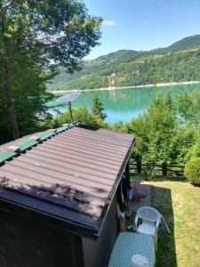 a house with a deck with a view of a lake at Zlatar Lake - cottage in Kokin Brod