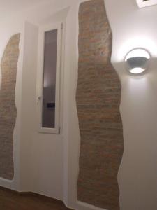 a room with a brick wall next to a door at Via d'acqua Al Mulino -City Center- BO in Bologna
