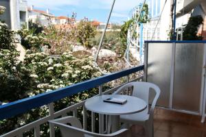 a white table and two chairs on a balcony at Seaview- 2 Space - selfcatering Apartment - Helen No 3 in Xiropigado +11 photos