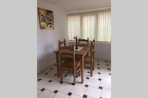 a dining room with a wooden table and chairs at A Home Away from Home in Ipswich