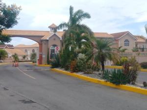 a building with palm trees in front of a street at Irie HideAway - Private Studio in Gated Community --Caribbean Estates, Portmore in Goshen Pen