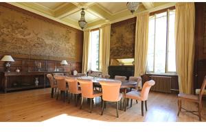 a dining room with a table and chairs at Château du Grava in Haux