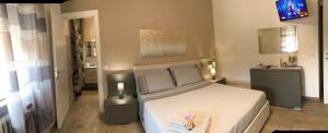 a bedroom with a white bed and a sink at Cà Nicola 1 in Cortemaggiore