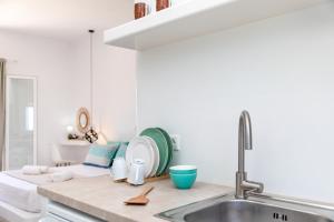 a kitchen with a sink and a plate on a counter at Elysium Beachfront Residences by kalais - A 10 Minute Drive Away From Naxos Town in Plaka