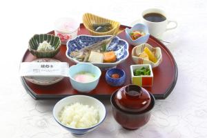a tray of food on a table with bowls of food at Numazu River Side Hotel in Numazu