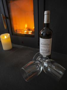 a bottle of wine sitting on a table with a candle at Riccal Dale Cottage in Helmsley