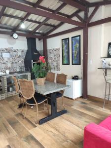 a dining room with a table and chairs in a room at TERRAÇO DA BARRA in Florianópolis