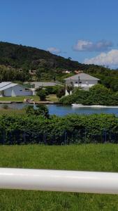 a view of a river with houses and a fence at TERRAÇO DA BARRA in Florianópolis
