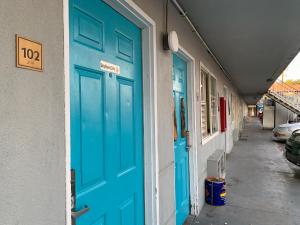 a blue door on the side of a building at Tiki Lodge Hotel Modesto in Modesto