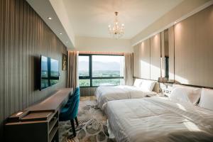 a hotel room with two beds and a television at Grand Hotel Lili in Taitung City +37 photos