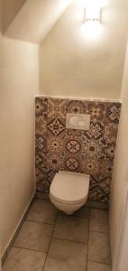 a bathroom with a toilet and a tile wall at Cosy Lake cottage, 300m2 lake area just for you ! in Maria Wörth +20 photos