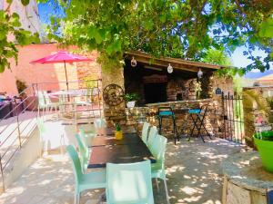 a patio with a table and chairs and a building at Gîte Emma in Santo-Pietro-di-Tenda +4 photos