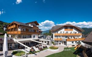arial view of a hotel with mountains in the background at Hotel Oberwirt in Feldthurns