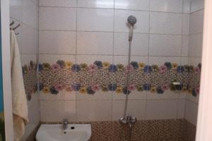 a bathroom with a shower with a sink at jabal shams moon in Al Ḩamrāʼ