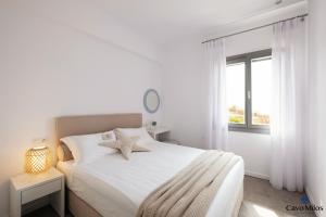 A bed or beds in a room at Cavo Milos