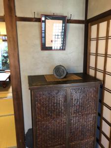 a wooden cabinet in a room with a mirror at 一棟貸し町家Keiko in Kyoto