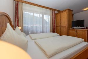Postel nebo postele na pokoji v ubytování Hotel Garni Elisabeth