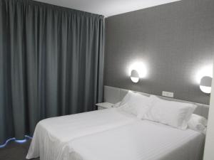 Posteľ alebo postele v izbe v ubytovaní Hotel Ton