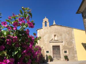 an old church with flowers in front of it at San Cerbone in Porto Azzurro