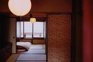 a room with a door leading to a bedroom with a window at 一棟貸し町家Keiko in Kyoto