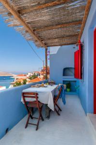 a table on a balcony with a view of the ocean at Atlantis Houses in Halki