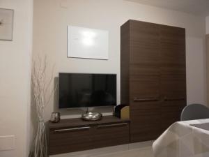 a large wooden cabinet with a television in a room at Appartamento Le Moulin in Aosta