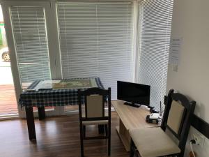 a living room with a table and a television at Shabla Lux Guest Houses in Shabla
