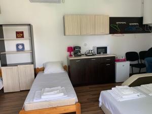 a small room with two beds and a kitchen at Shabla Lux Guest Houses in Shabla