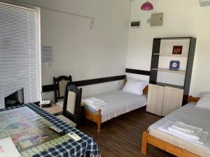 a room with two beds and a table in it at Shabla Lux Guest Houses in Shabla