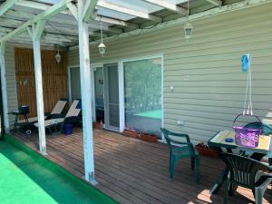 a screened in porch with chairs and a table at Shabla Lux Guest Houses in Shabla